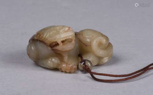 A CELADON JADE CARVING OF BUDDHIST LION