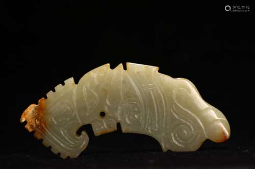 A CELADON JADE CARVED HUANG PENDANT