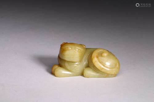 A YELLOW JADE CARVED RECUMBENT MYTHICAL BEAST
