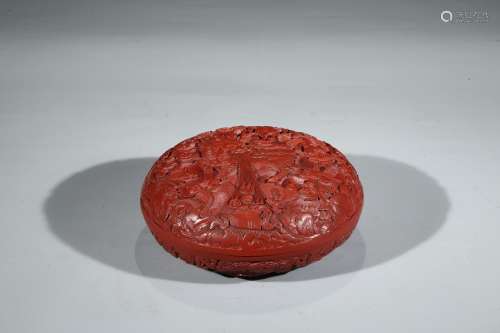 A CINNABAR LACQUER 'BUDDHIST LIONS' BOX AND COVER