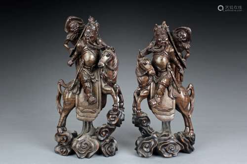 A PAIR OF WOODEN GUANYU ON HORSE CARVINGS INSET WITH SILVER LINES