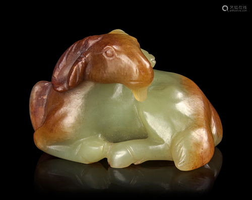 A Russet and White Jade Figure of a Ram Len…