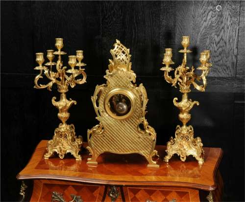 A Set of Gilt Bronze Candle Holders and Table Clock