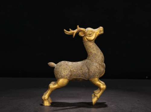 A GILT BRONZE DEER SHAPED ORNAMENT