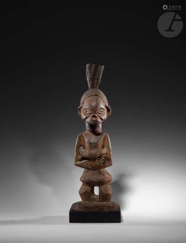 Une ancienne statuette nkishi en pied avec sa corne fétiche et une ceinture-charge ventrale en