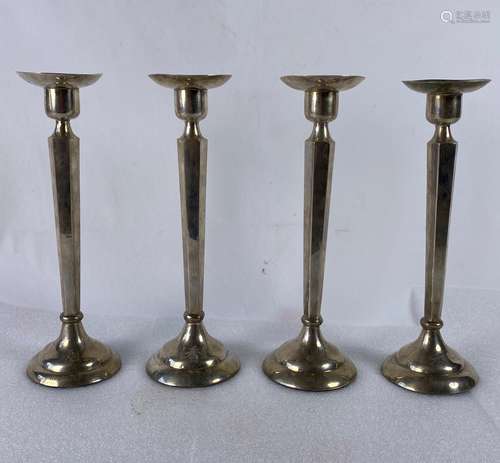 A Set Of Four Silver Candlestick Holders