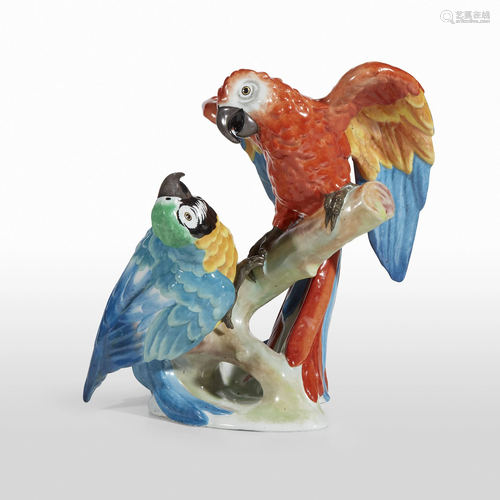 A pair of French painted porcelain parrots in…