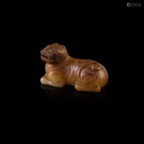WHITE JADE WITH YELLOW SKIN CARVING OF A BUDDHIST DOG                         MING-QING DYNASTY