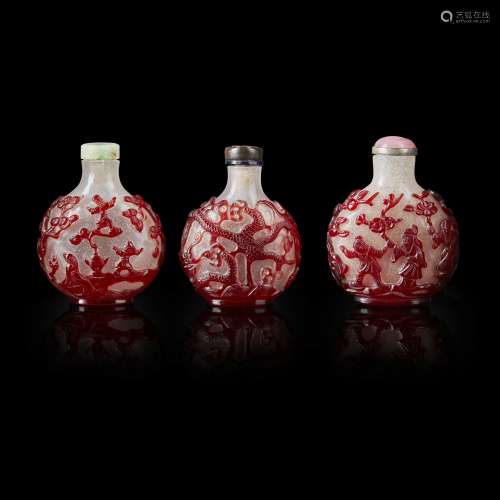 GROUP OF THREE RED OVERLAY PEKING GLASS SNUFF BOTTLES                         QING DYNASTY, 19TH CENTURY