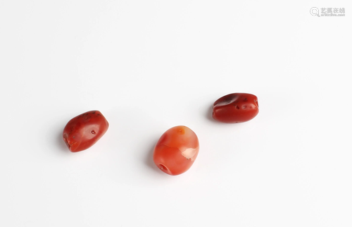 A Group of Three Antique Red Agate Beads