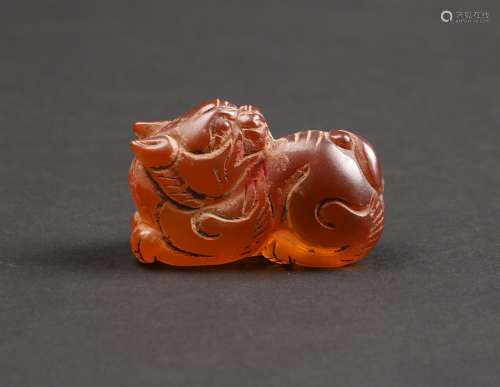 A CARVED AMBER BEAST