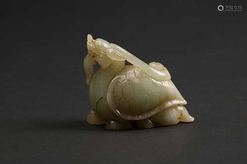 A CARVED CELADON JADE BEAST