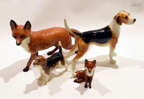 Beswick model of a fox, together with a smaller model of a fox and with two models of hounds