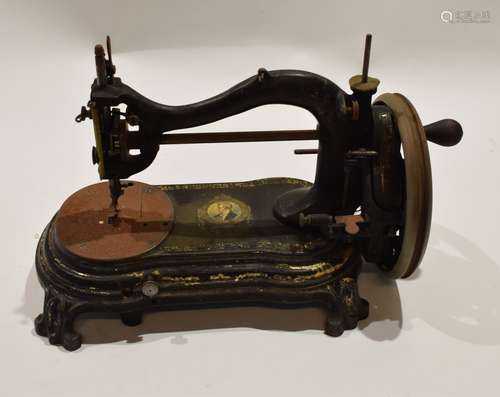 Late 19th century black cast metal sewing machine, indistinct trademark with the head and