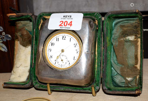 French gilt metal cased circular faced bedside clock, with hallmarked silver mount in case, 7cm wide