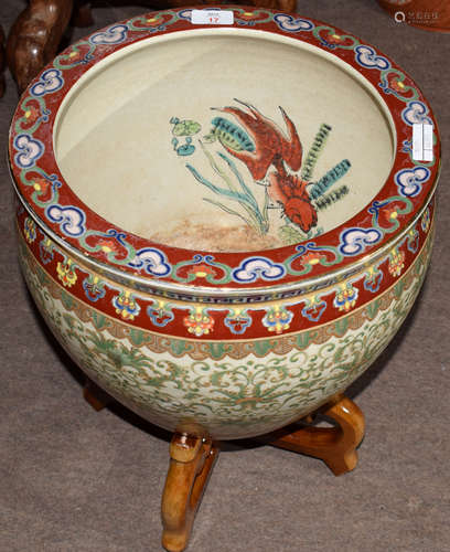 Chinese porcelain fish bowl with a scrolling design in green enamel below a polychrome rim mounted