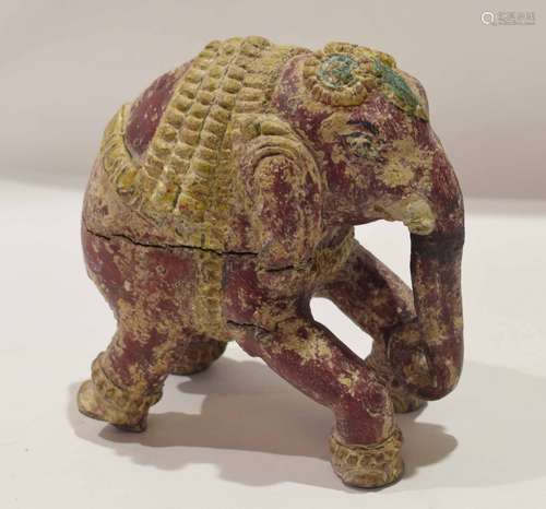 An unusual Tang style model of an elephant carved in wood with traces of original colouring, 16cm