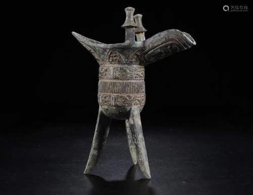 A CHINESE ARCHAIC BRONZE WINE …