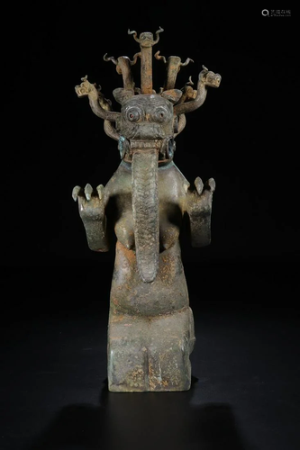 A CHINESE ARCHAIC BRONZE ANIM…