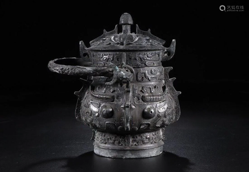 A CHINESE ARCHAIC BRONZE WINE …