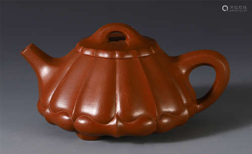 A CHINESE YIXING ZISHA CLAY CARVED TEA POT