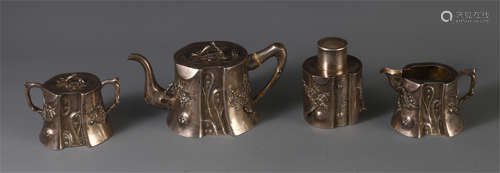 A SET OF CHINESE SILVER CARVED TEAPOT