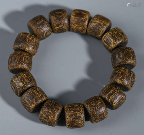 A CHINESE AGALWOOD CARVED BEAD BUDDHIST BRACELET