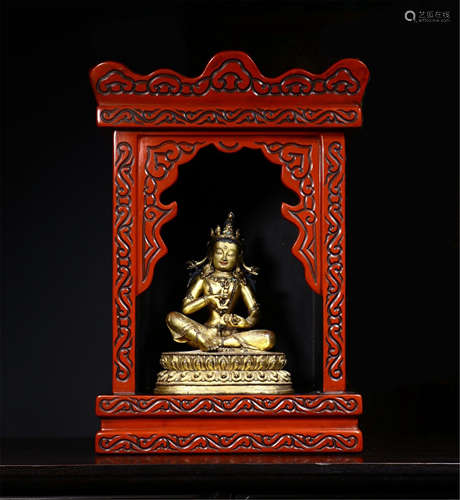 A CHINESE GILT BRONZE TARA IN ROSEWOOD NICHE