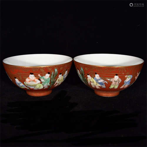 PAIR OF FAMILLE ROSE RED GROUND 'CHILDREN' BOWLS