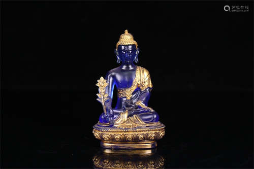 BLUE GLASS CARVED AND GILT 'BHAISAJYAGURU' SEATED FIGURE