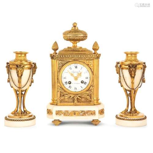 CHIMNEY GARNITURE, STYLE LOUIS XVI, NAPOLEON III Era in white marble and gilded bronzes after a model by François Vion, consisting of a clock in the shape of a terminal and a pair of cassolettes. The dial bears an Ageron signature, is flanked by half columns and surmounted by a flamed vase