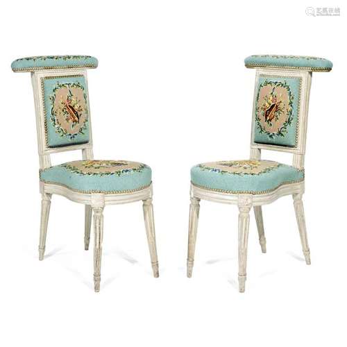 PAIR OF DECKCHAIRSWITH JULIAN DENIS LOUIS XVI period in moulded white lacquered wood. The flat back is topped by an armrest. Horseshoe shaped seat. Tapered legs with asparagus grooves. Stamped Julienne, Louis XVI period. Tapestry upholstery with a blue background decorated in old pink leafy reserves of allegories of music.