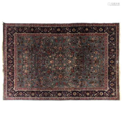 RUG TABRIZBlue azure background, dense decoration of flowering stems, palms and ribbons. Sapphire blue border of garlands of flowers between pink braids. A large Tabriz carpet. 281 X 385 CM - 110 5/8 X 151 5/8 IN.