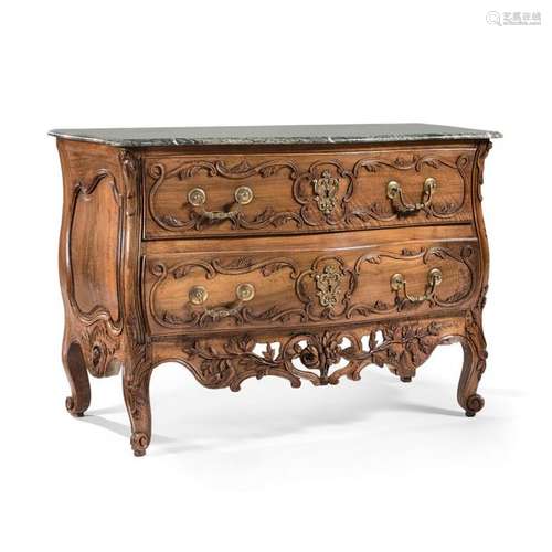 PROVENçAL COMMODITY, Epoque LOUIS XV Curved carved and molded walnut opening with two drawers in front. Apron with openwork motifs of flowers and foliageMoving uprights and feet ending in snail. Drawer handles and lock entries in chiselled and gilded bronzeGreen marble plate added at the back. A mid-18th century veneer chest of drawers. HEIGHT: 90 cm - WIDTH: 130 cm - PROF: 65 cm - HEIGHT 35 3/8 IN - WITDH 51 1/8 IN - DEPTH 25 5/8 IN