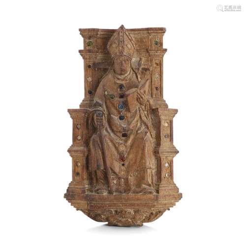 SAINT THOMAS BECKET IN TRÔNE, BEGINNING OF THE XVIth CENTURY. Statuette of an oak wall lamp resting on a console supported by a cherub holding a sword across the nape of the neckSouthern Netherland, Limburg ?, early 16th century