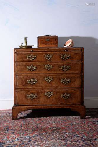 A George I walnut and feather banded chest of drawers, circa 1720