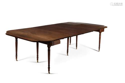 ϒ A Regency mahogany and ebony inlaid concertina action extending dining table, circa 1815