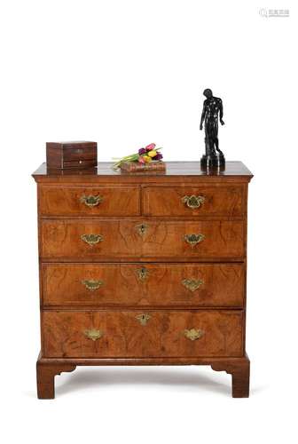 A George I walnut and feather banded chest of drawers, circa 1720