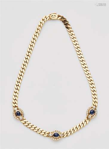 An 18k gold and sapphire necklaceSmooth chain interspersed with three sapphire cabochons (in total