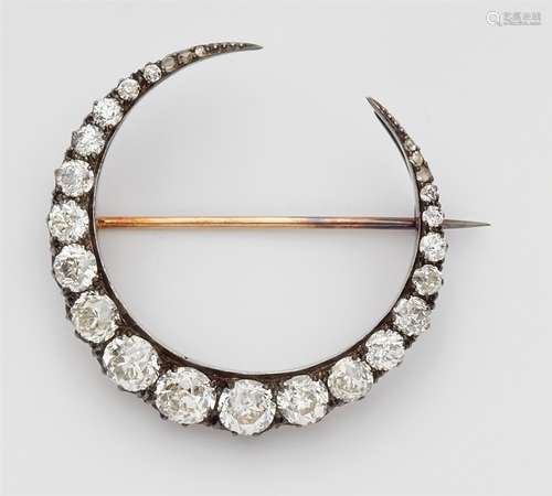 A diamond half moon broochA 14k gold and silver brooch set with six tiny rose-cut diamonds and 19