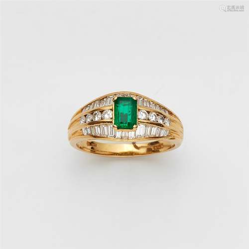 An 18k gold and emerald ringThe pierced ring band set with eight brilliant-cut diamonds (in total c.