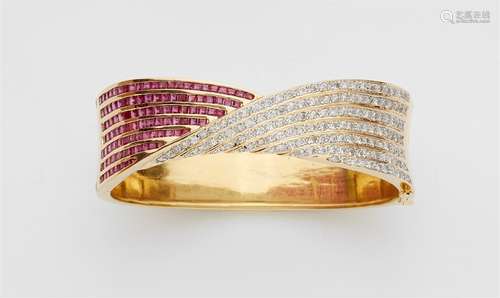 An 18k gold, ruby, and diamond bangleYellow and white gold hinged bangle designed as a stylised