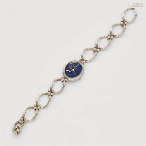 An 18k gold and lapislazuli ladies cocktail watch.The chain strap with bark-like textured decor