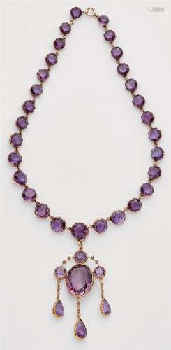 A 14k red gold and amethyst necklace with pendantA slightly graduated rivière necklace set with 29