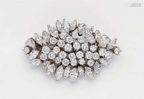 An 18k white gold and diamond broochFully set with 52 brilliant-cut, navette-cut, and pear-cut