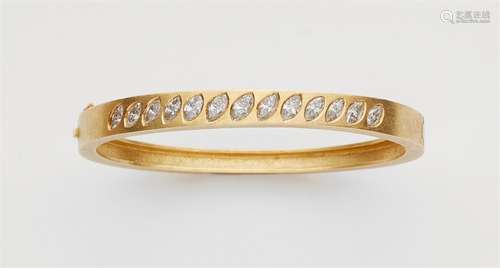 An 18k gold diamond bangleForged oval matte gold bangle àjour set with 13 graduated navette-cut