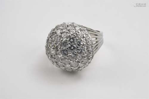 A bombé form platinum and diamond ringA platinum ring with 10% iridium. Raised bezel pavé set with