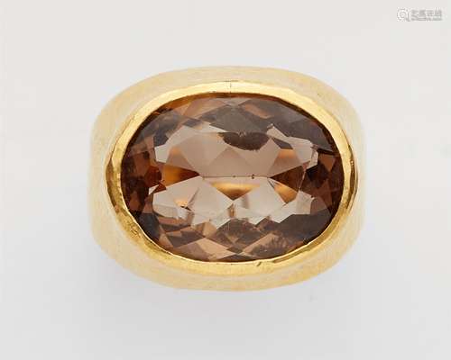 A 21k gold and smoky quartz ringForged ring band with martelé decor set with an oval smoky quartz