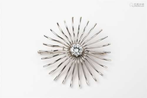 A 14k white gold sun brooch with a diamond solitaireGold wire sunburst form set with a brilliant-cut