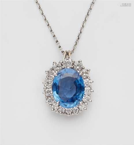 An 18k white gold diamond and sapphire pendantA pendant with a hinged bail, cluster set with a